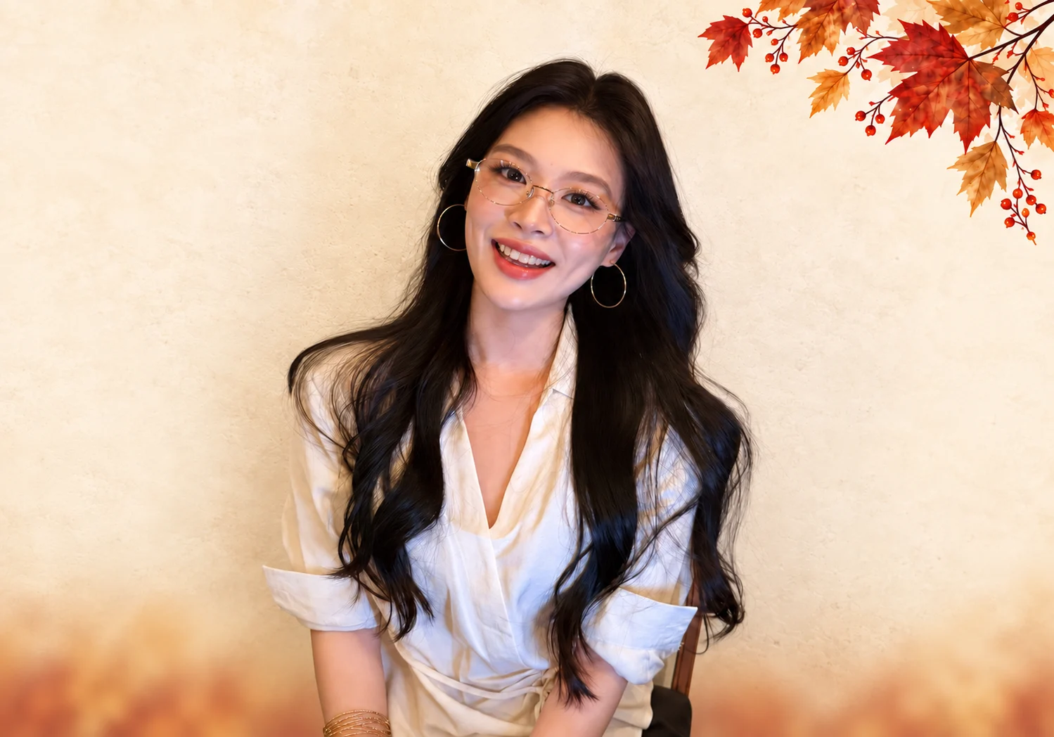 MUJOSH campaign model wearing gold optical frames, with warm autumn maple-leaf artwork.